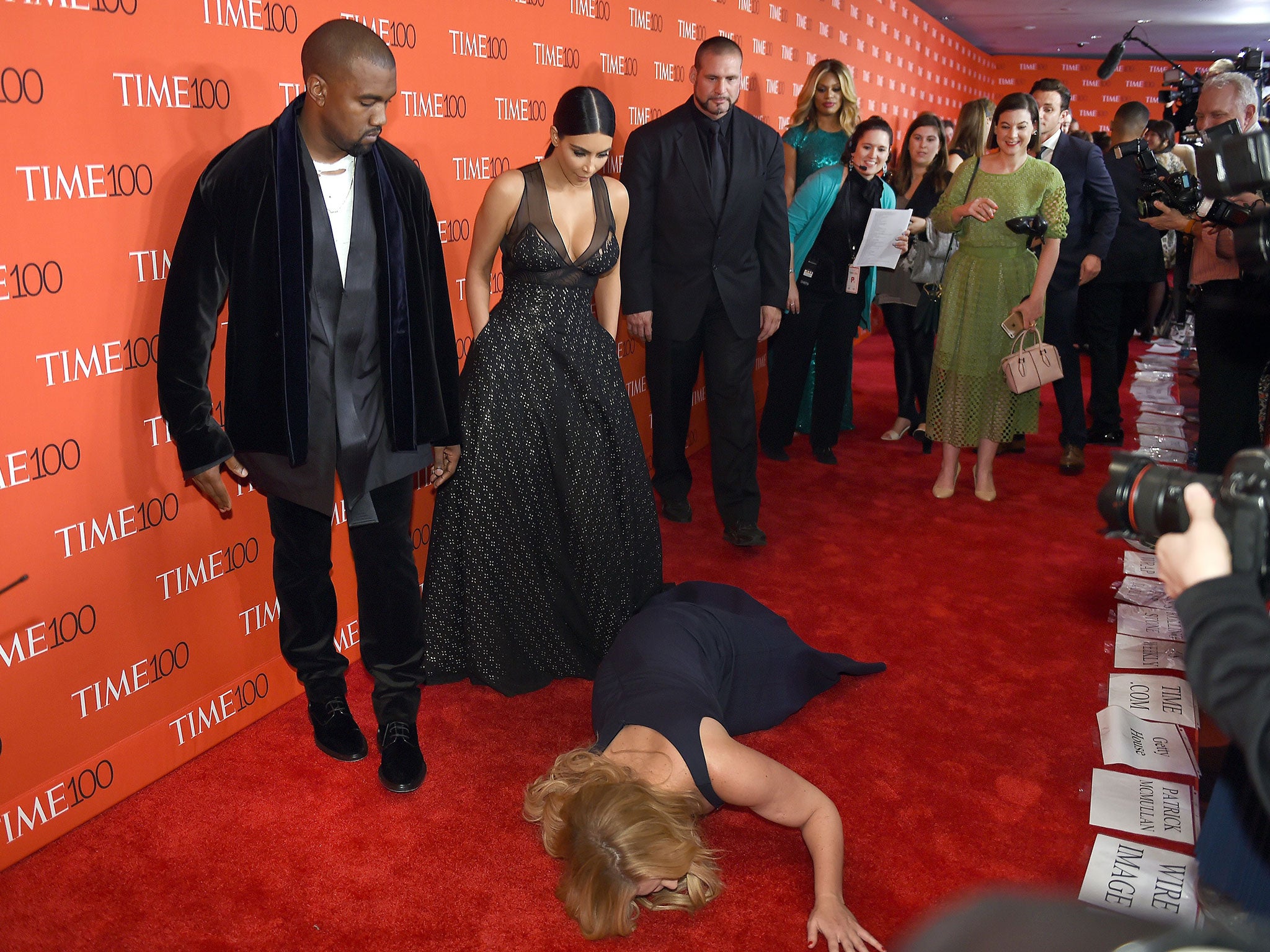 Honoree and Comedian Amy Schumer pretends to trip and fall on the floor in front of honorees Kim Kardashian and Kanye West as they attend the Time 100 Gala celebrating the Time 100 issue of the Most Influential People at The World at Jazz at Lincoln Cente