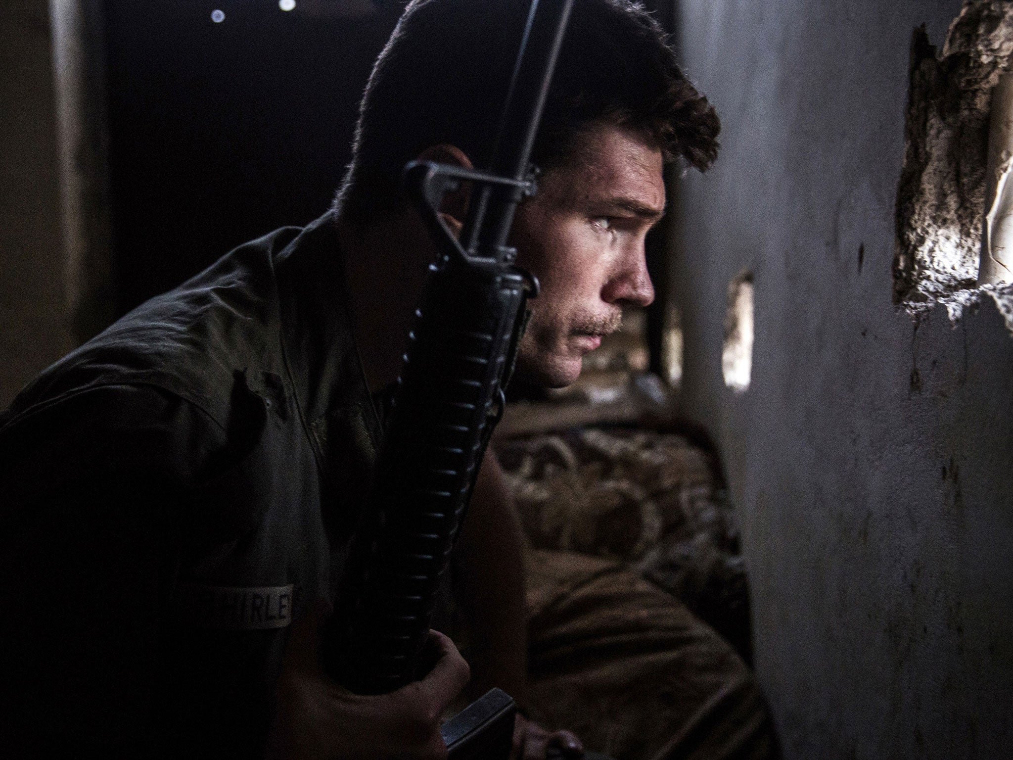 A 23-year old fighter and ex-US marine from the US, nick-named by Kurdish fighters as Hewal Agir, guards a look out point during clashes with Isis