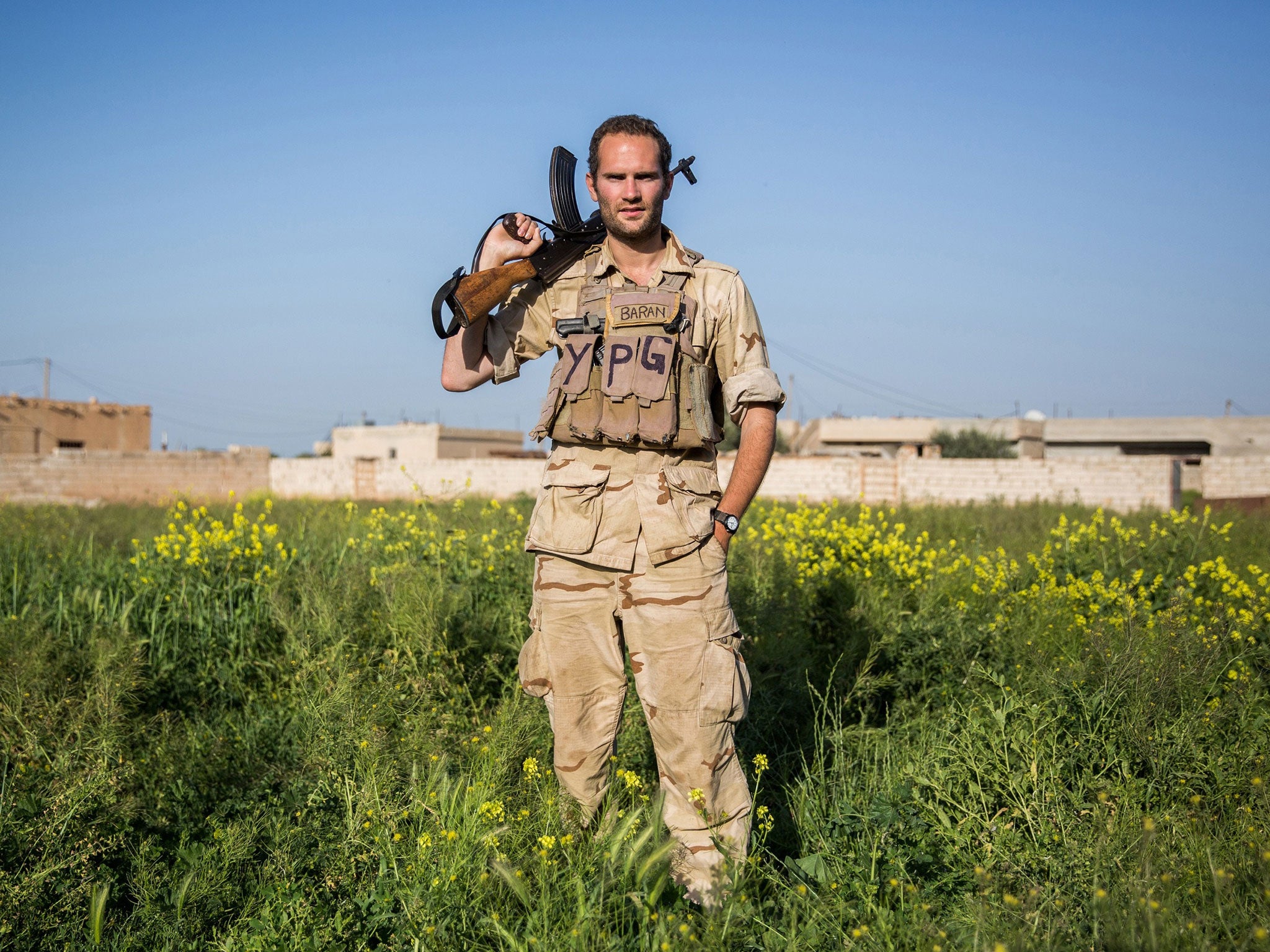 A 28-year old foreign fighter from the UK, nick-named by Kurdish fighters as Hewal Baran, poses for a photo