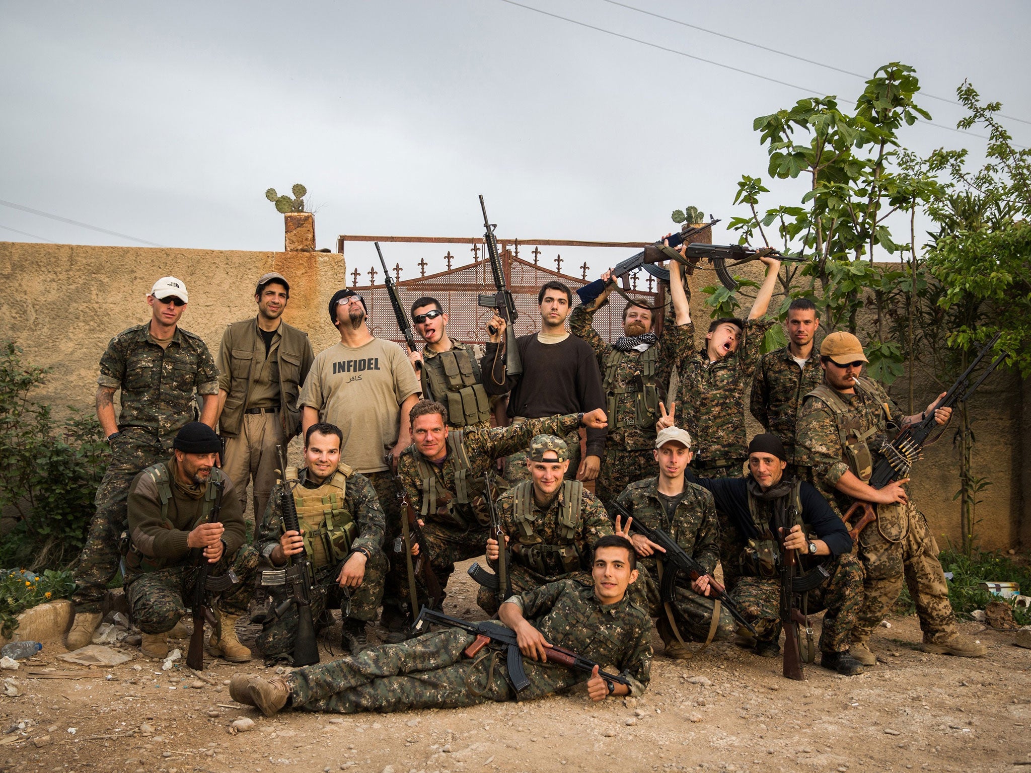 A group of international foreign fighters pose for a photo on April 16, 2015, in the outskirts of the north-western Syrian town of Tal Tamr