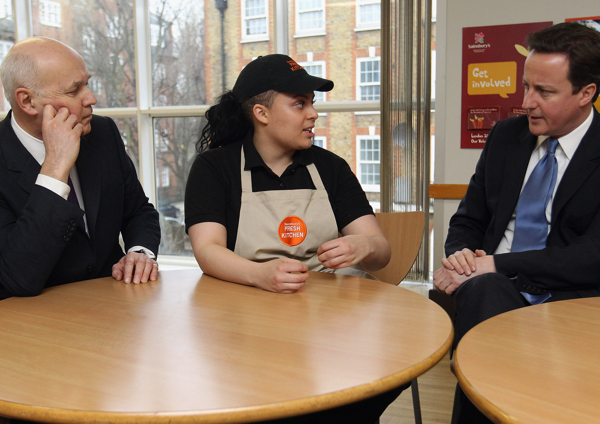 Iain Duncan Smith and David Cameron talk to a Sainsbury's worker to try and figure out how buying groceries works