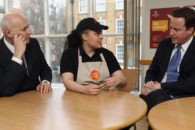 Iain Duncan Smith and David Cameron talk to a Sainsbury's worker to try and figure out how buying groceries works