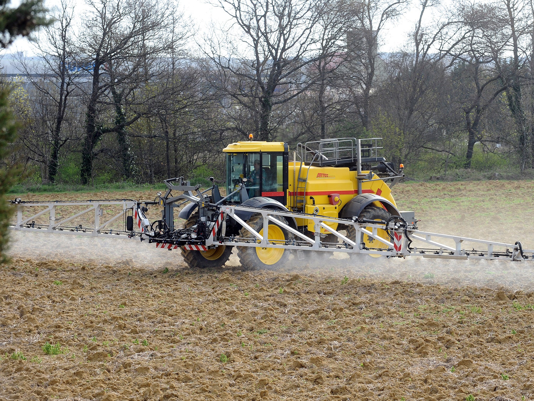 A field is sprayed with pesticides