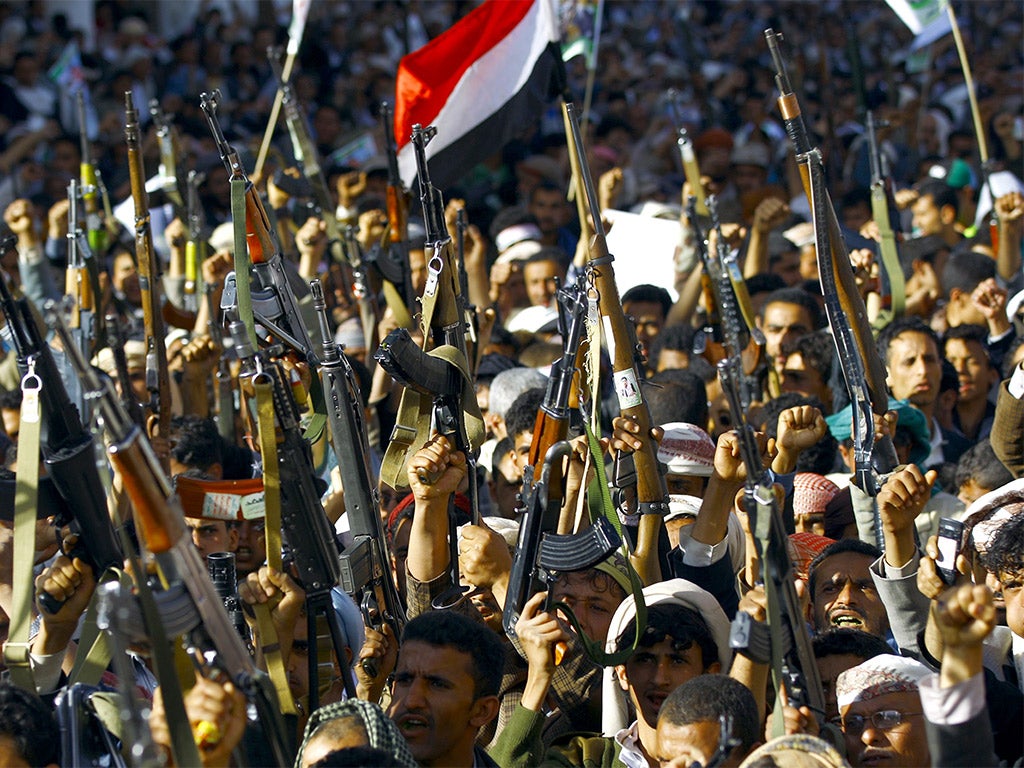 Supporters of the Houthi movement brandish their weapons as they take part in a demonstration against the Saudi-led military 'Decisive Storm' air campaign, in the capital Sanaa, on Wednesday