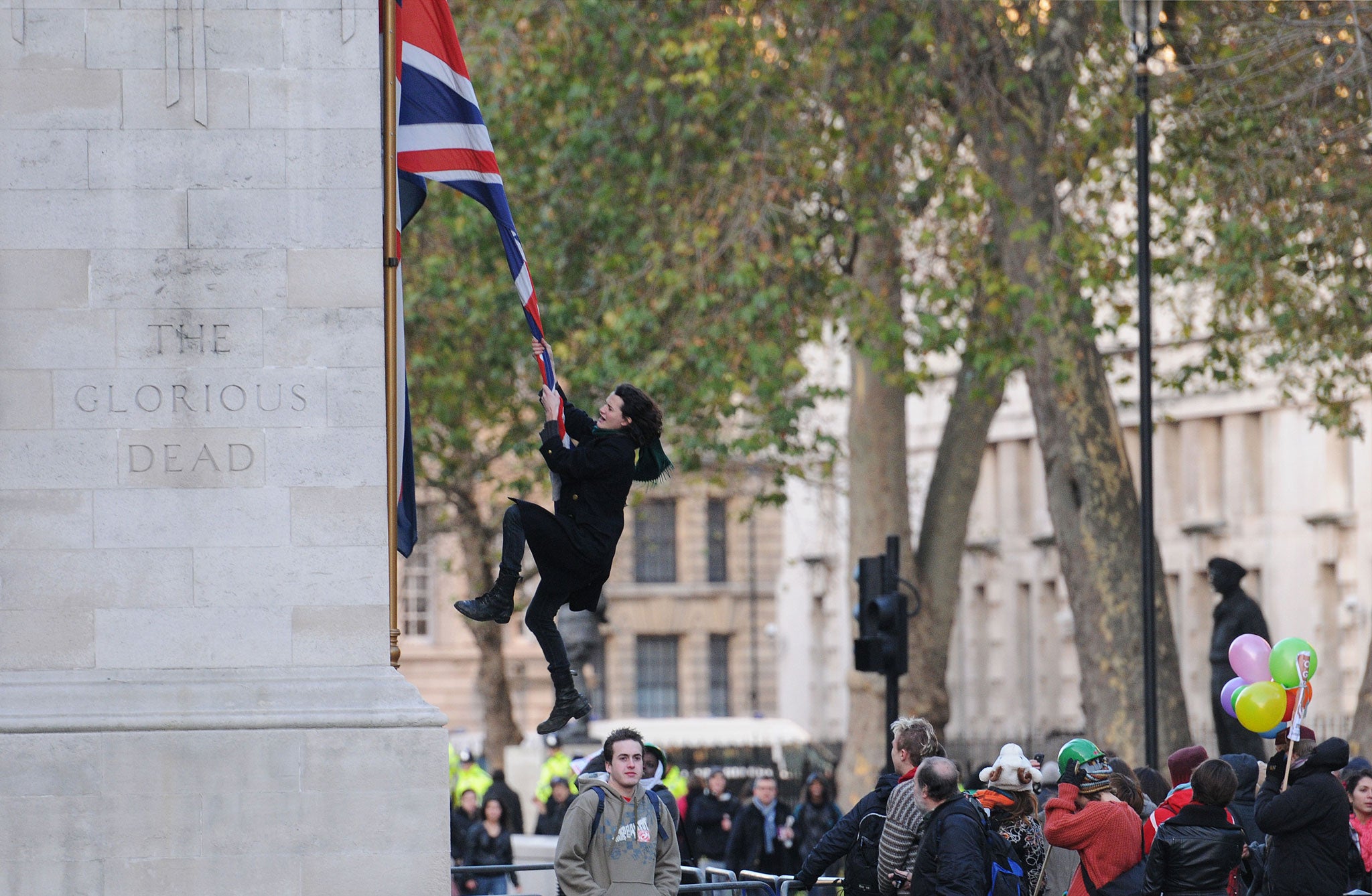 Gilmour received death threats after images appeared of him swinging from a flag on the Cenotaph during demonstrates against higher tuition fees in 2010
