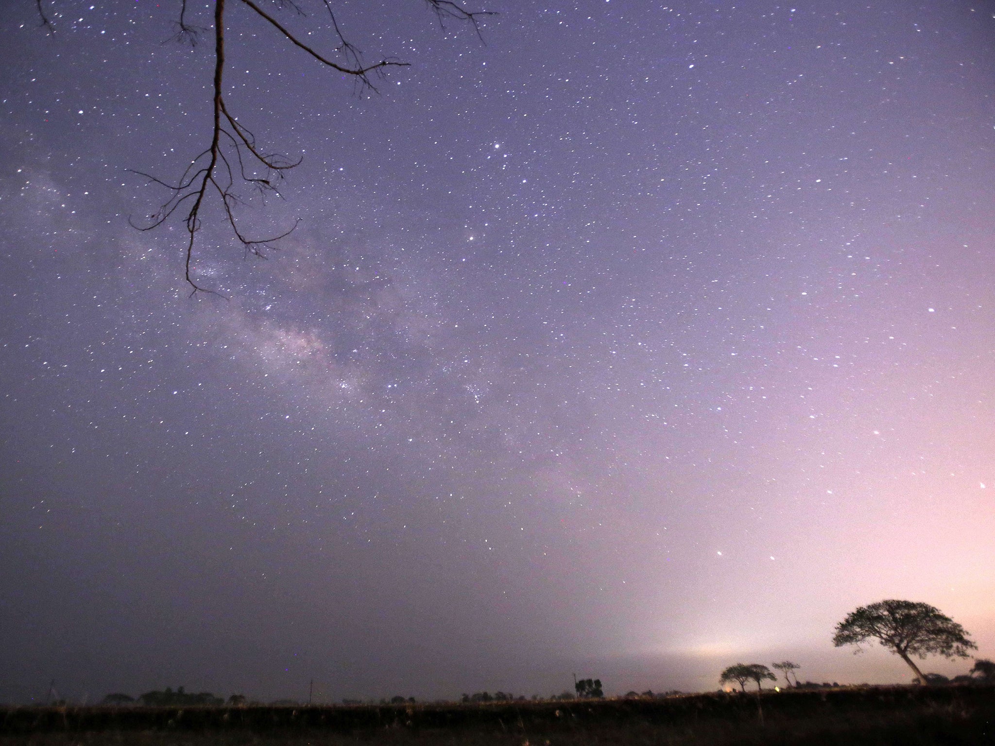 The Lyrids meteor shower passing near the Milky Way in the clear night sky of Thanlyin, Myanmar