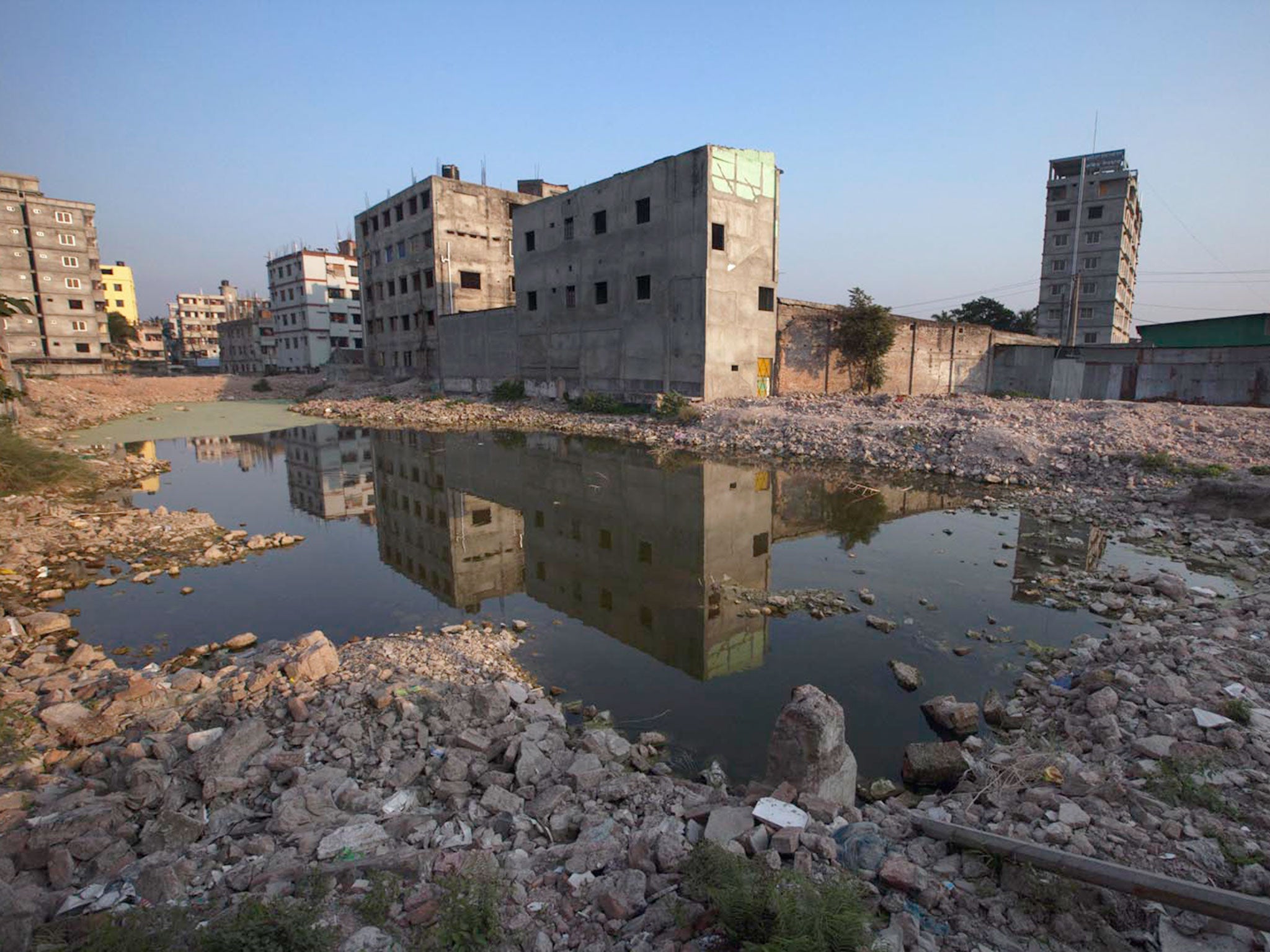 The Rana Plaza site turns into a marshy land as debris of the collapsed factories are removed. It is alleged that the eight-storey factory building was erected on a marshy land without following the building code of the country, which is largely blamed for the disaster © Md Nashirul Islam