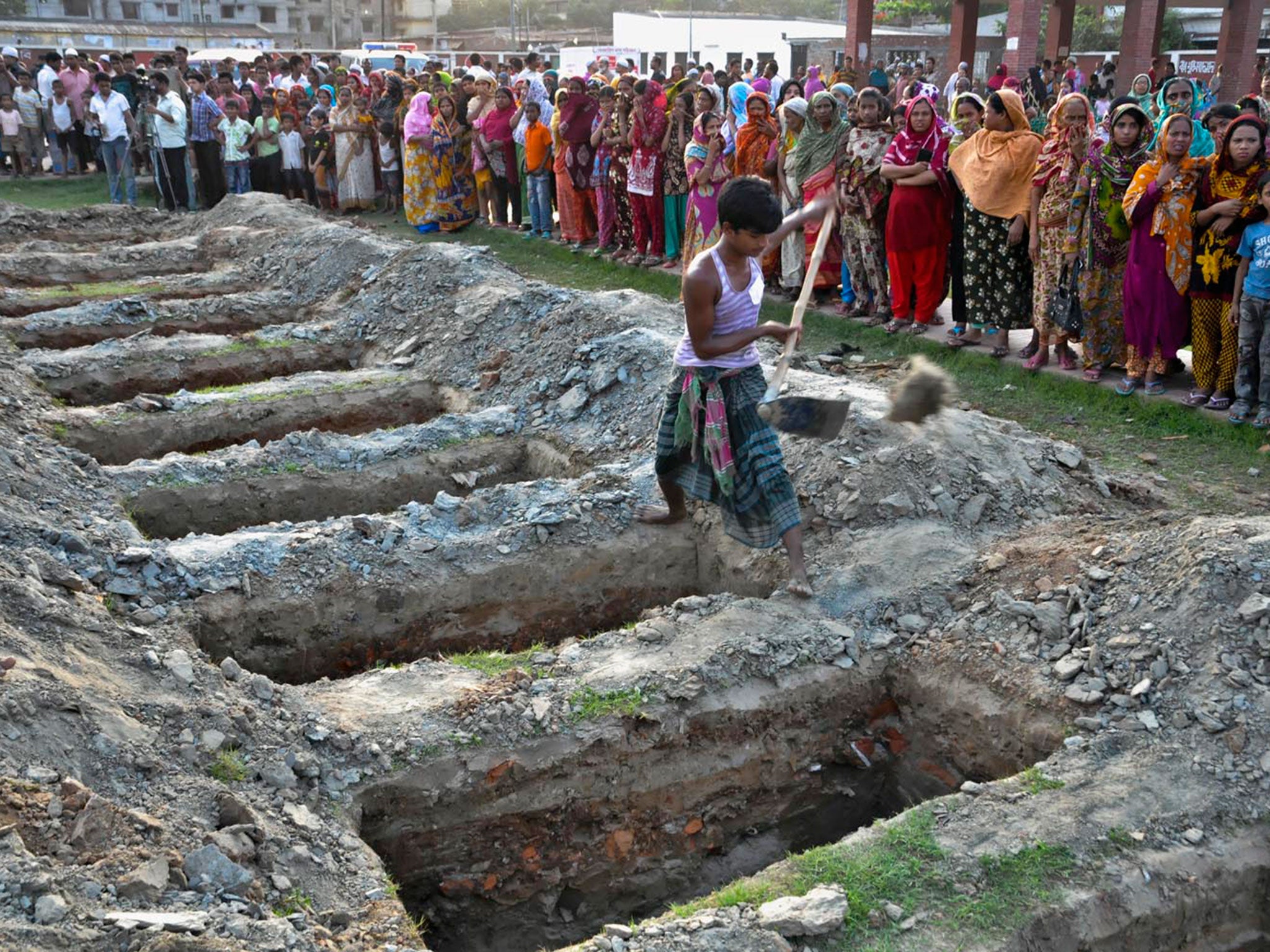 Authorities arrange the burial of many workers in a Dhaka graveyard as their identities could not be known to hand over the bodies © Indraji Ghosh