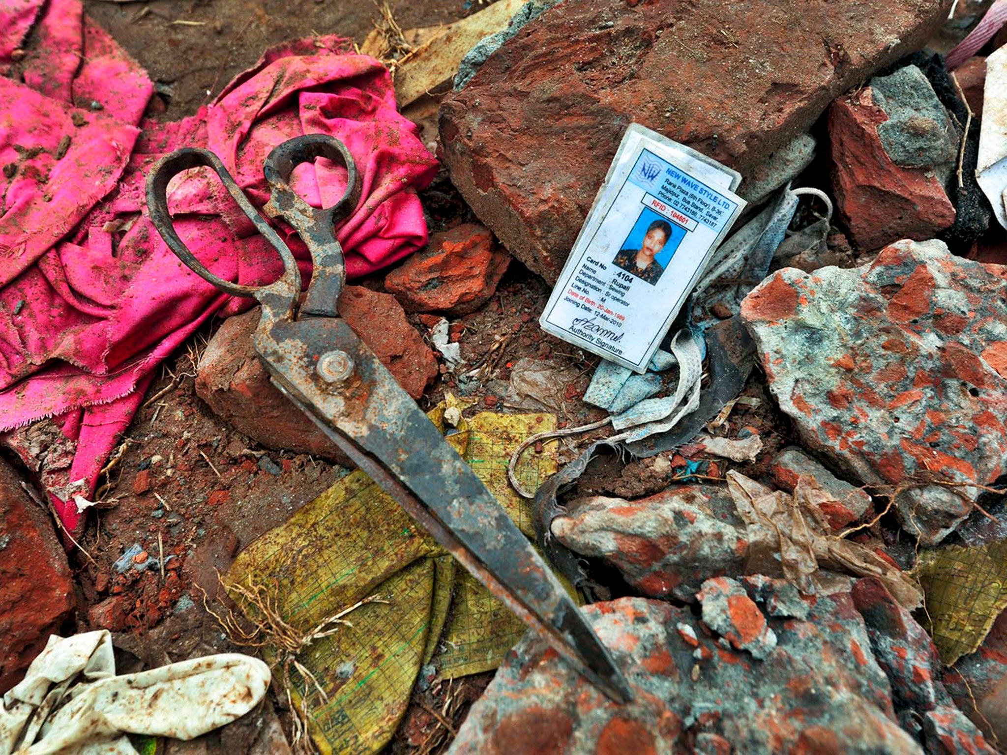 The ID card of a worker and a pair of scissors left abandoned in the site of the collapsed factory building in Savar © Khorshed Alam Rinku
