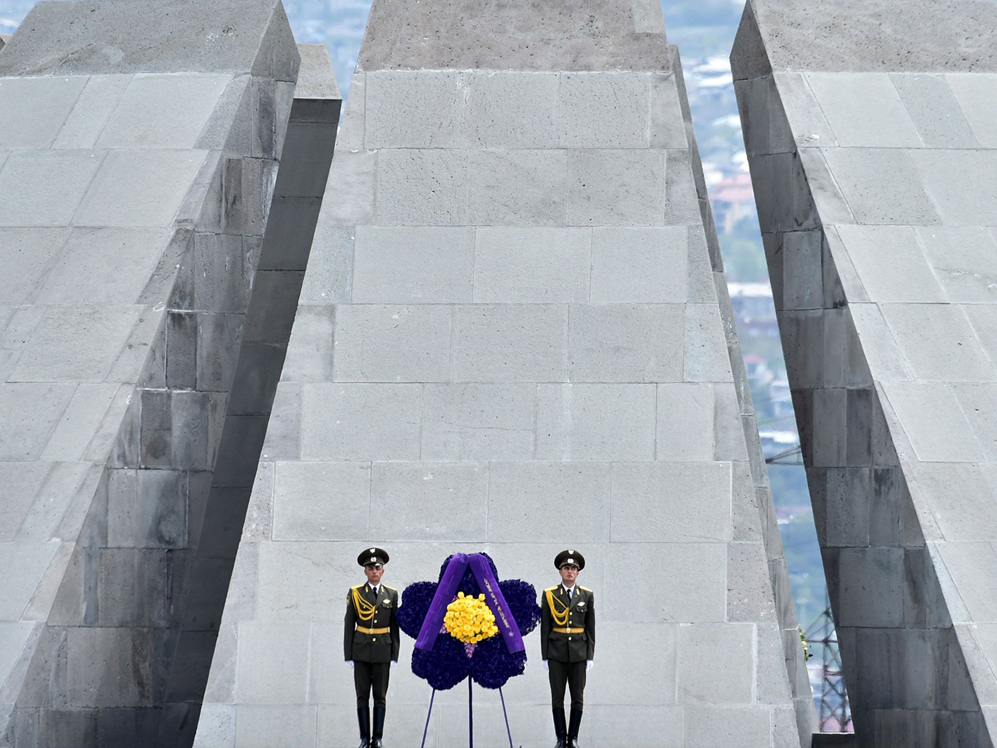 Soldiers stand guard in front of the Tsitsernakaberd Memorial in Yerevan during a commemoration ceremony for the 100th anniversary of the Armenian genocide
