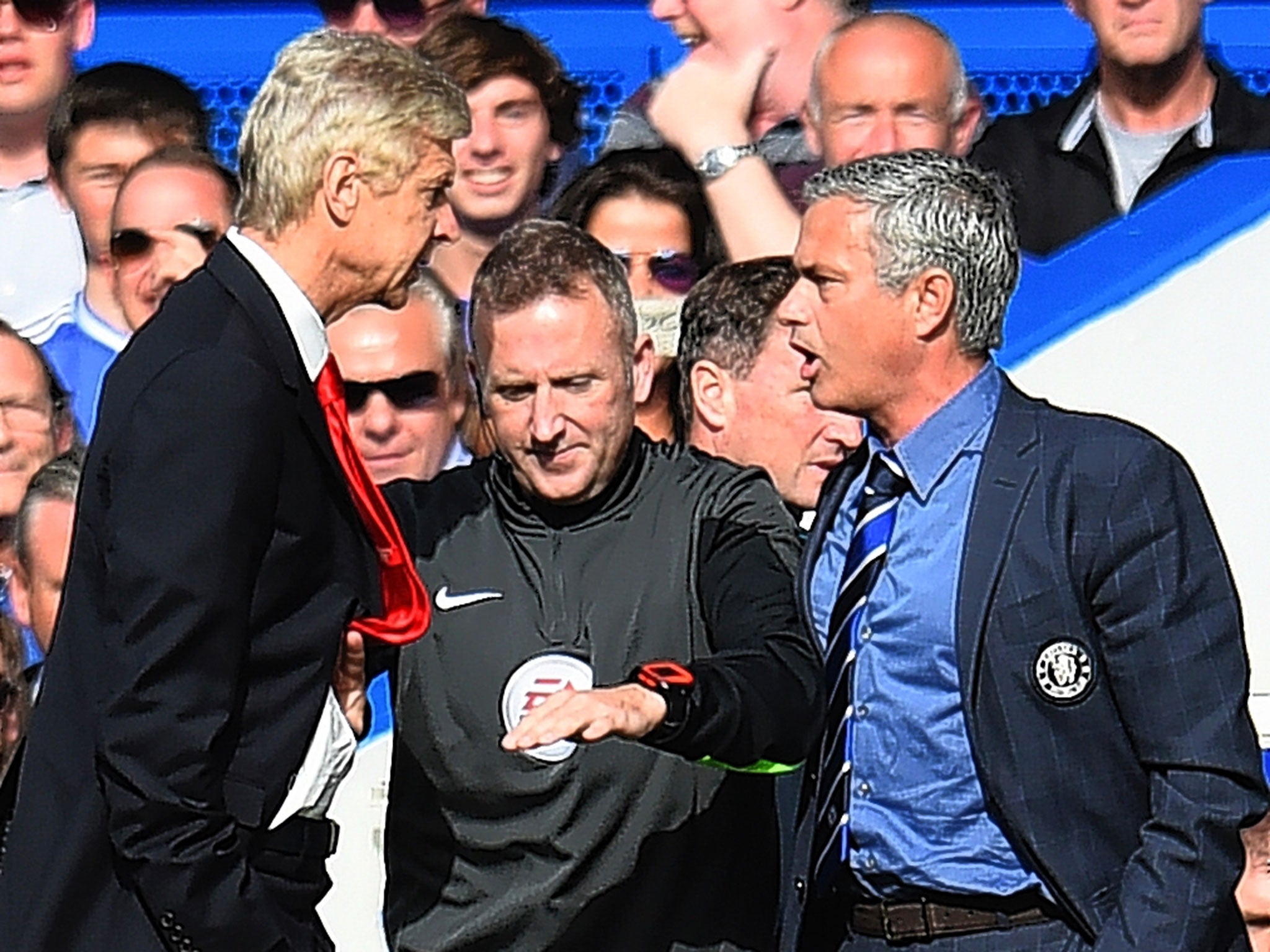 Arsène Wenger (left) and Jose Mourinho have to be separated by the fourth official, Jon Moss, during last October’s Premier League match at Stamford Bridge