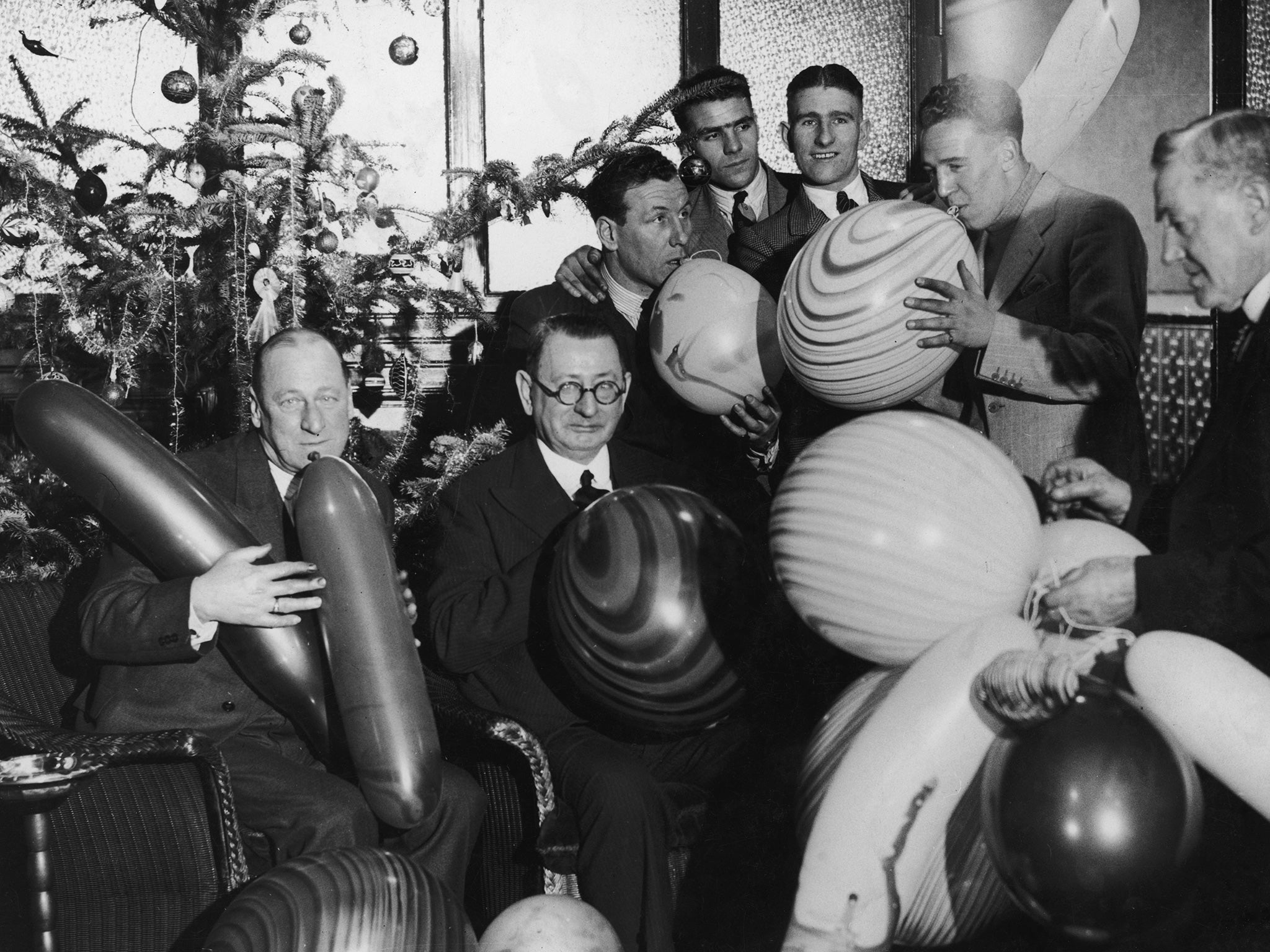 Liverpool’s players and directors show the likes of Raheem Sterling and Jack Grealish a more benign form of balloon fun at their 1936 Christmas party