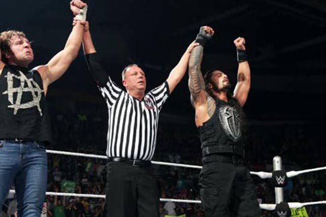 Dean Ambrose and Roman Reigns celebrate their victory
