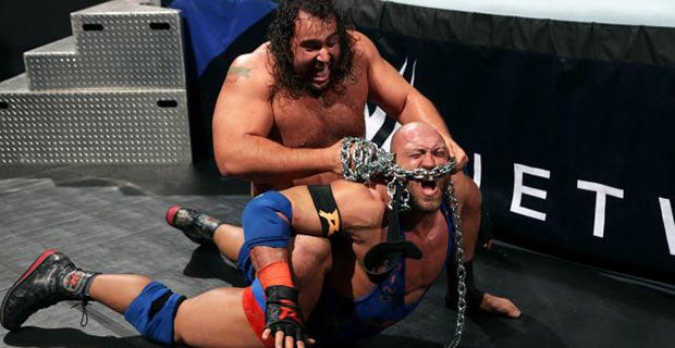 Rusev locks Ryback in the accolade with a steel chain