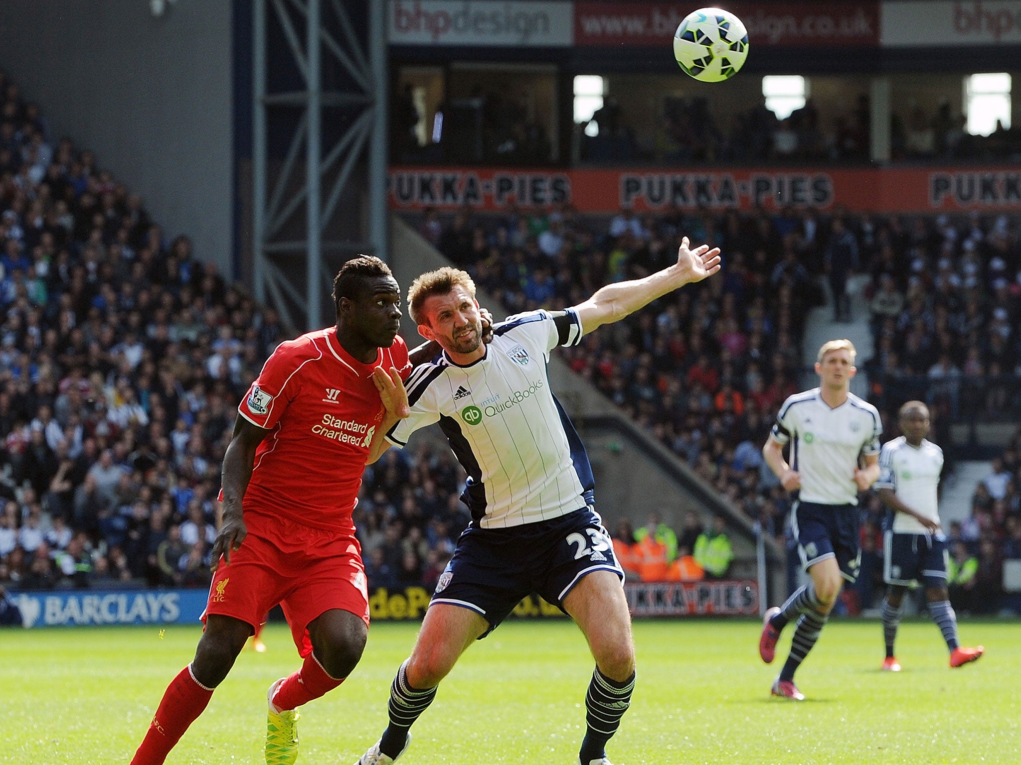 Mario Balotelli and Garath McAuley battle for possession