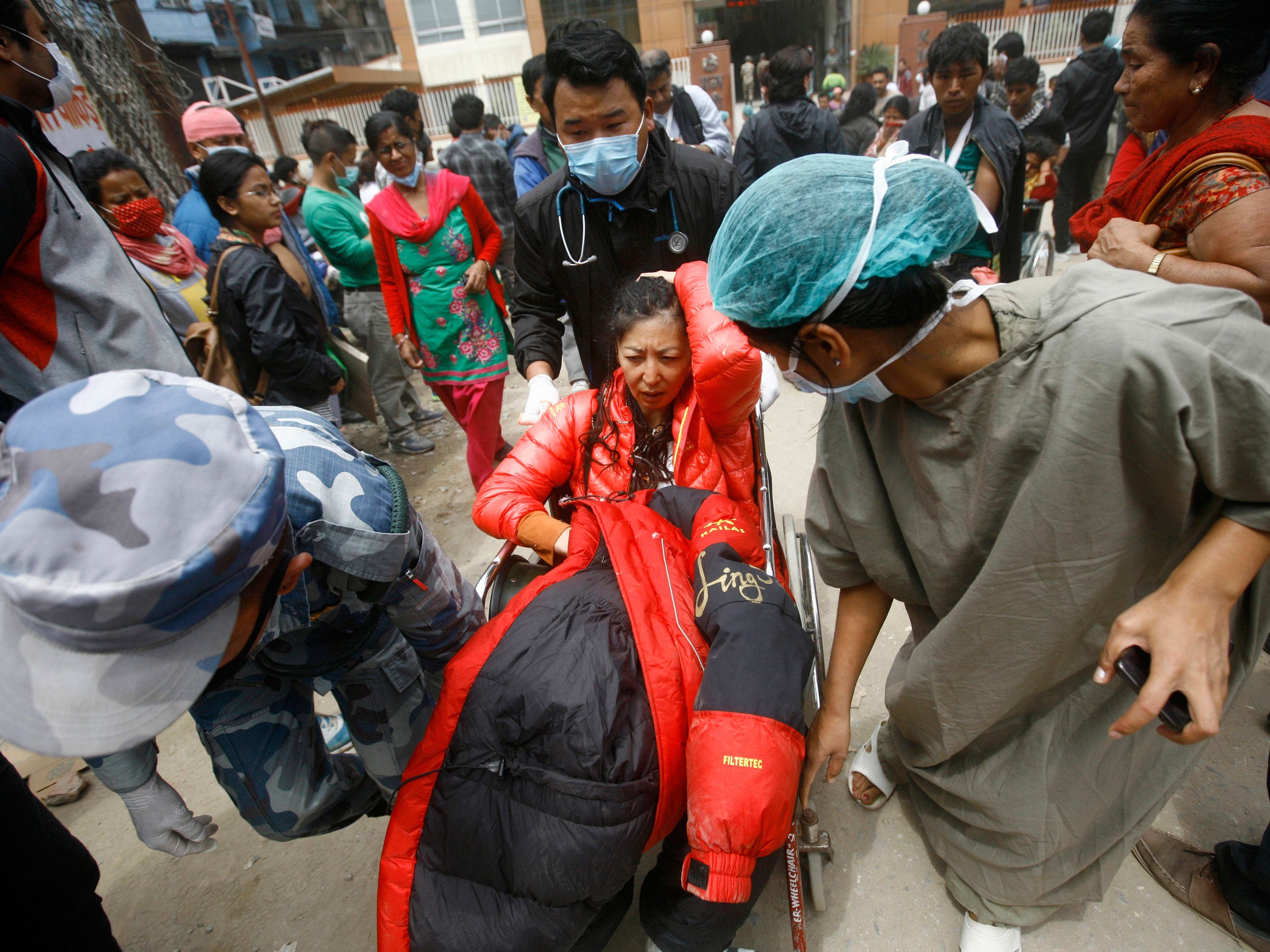 A Japanese tourist is taken on a wheelchair to a hospital after being evacuated from Mount Everest Base Camp