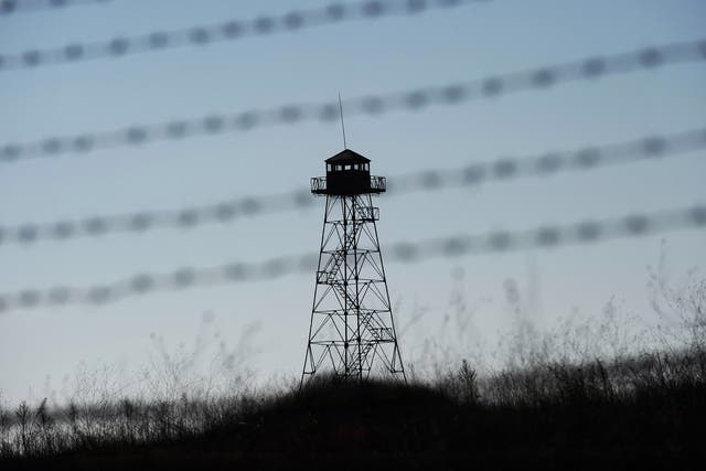 A watch-tower is seen behind barbed wire fence at the green-border near the Kapitan Andreevo border crossing point between Bulgaria and Turkey
