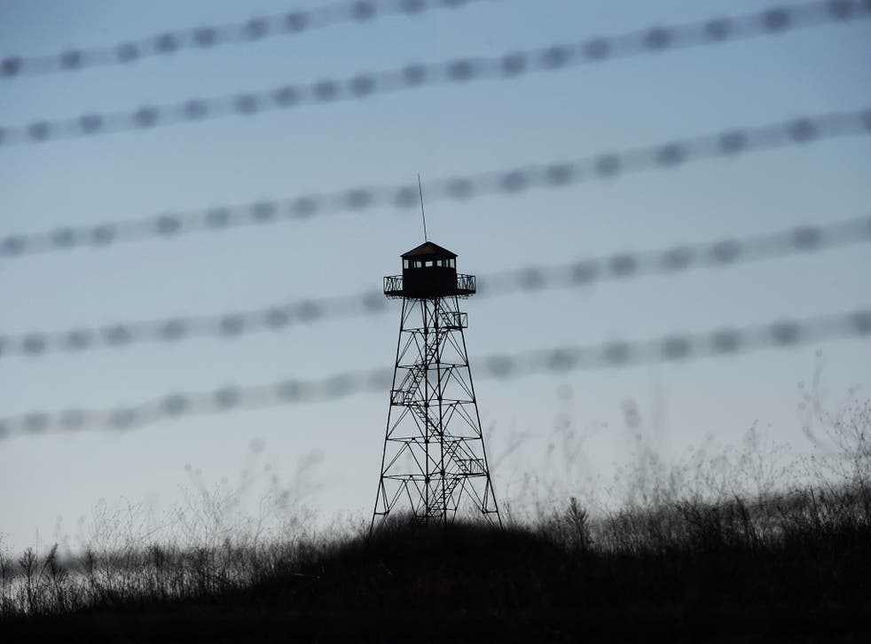 A watch-tower is seen behind barbed wire fence at the green-border near the Kapitan Andreevo border crossing point between Bulgaria and Turkey