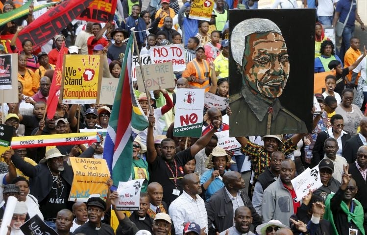 Demonstrators carry placards during a march against xenophobia in downtown Johannesburg (Image: Reuters)