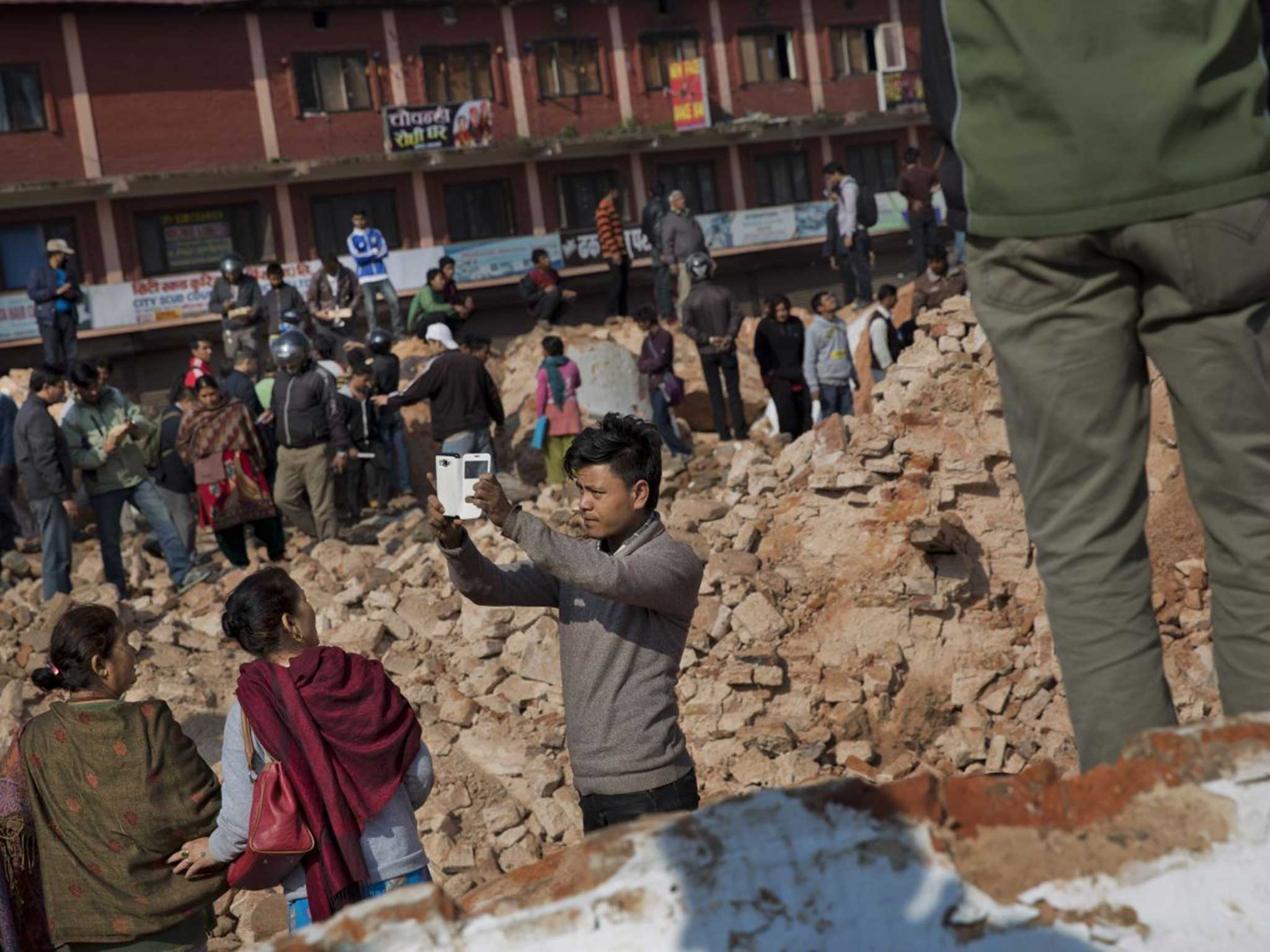 Amid the chaos, a man appears to take a selfie