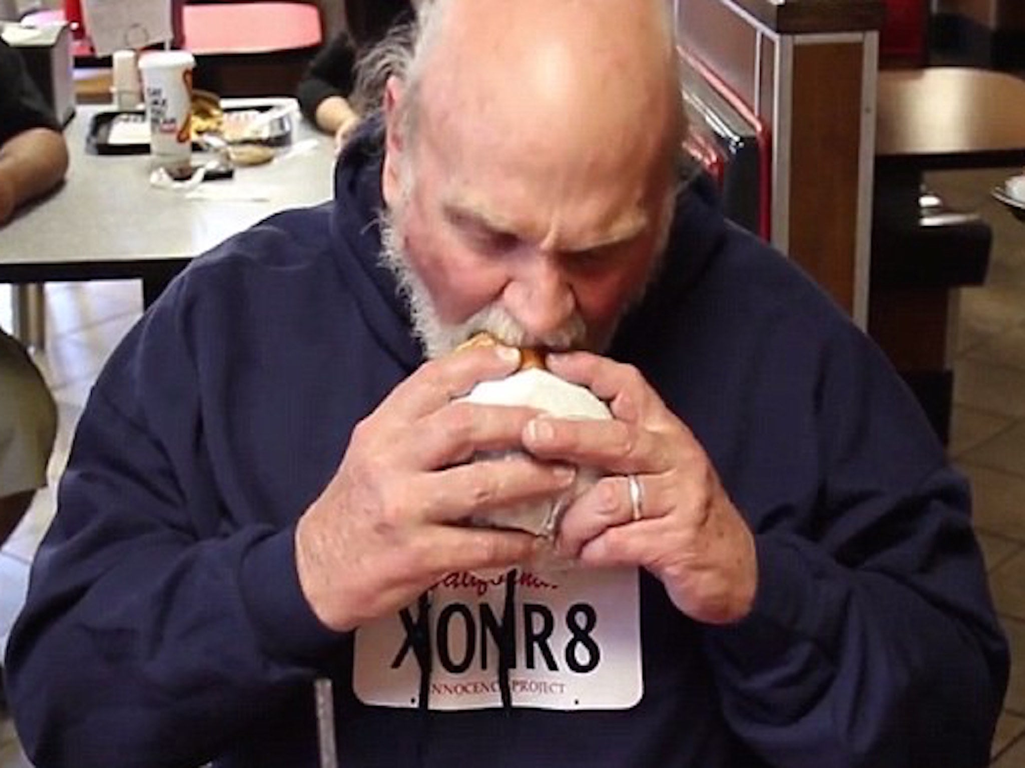 Michael Hanline eats a burger