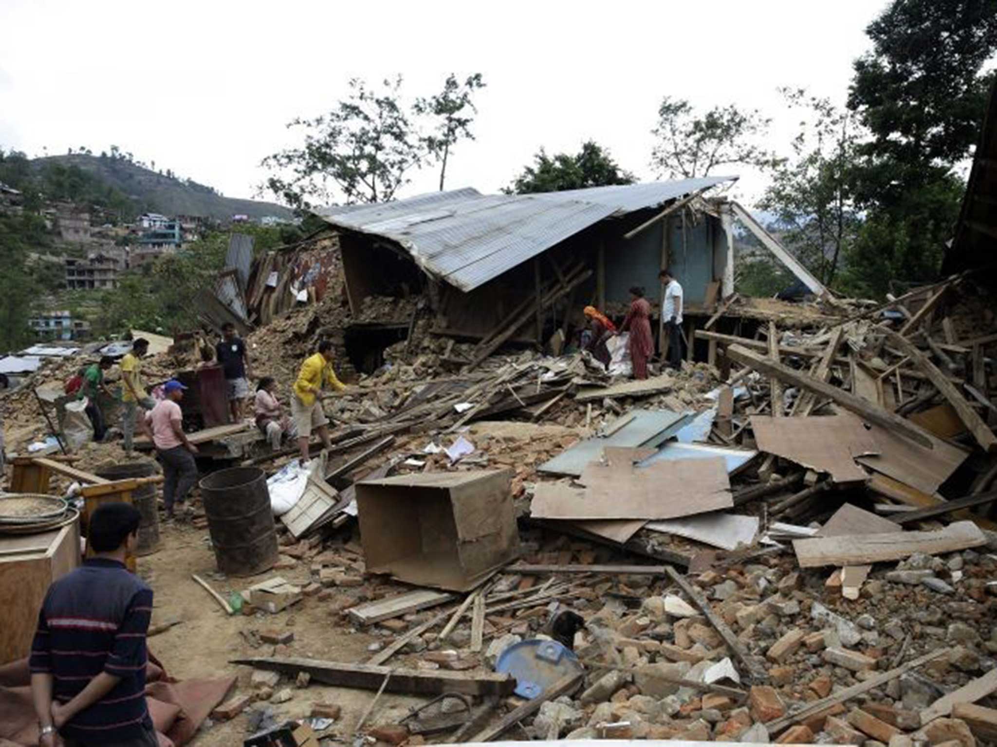 Villagers survey the damage just outside the capital