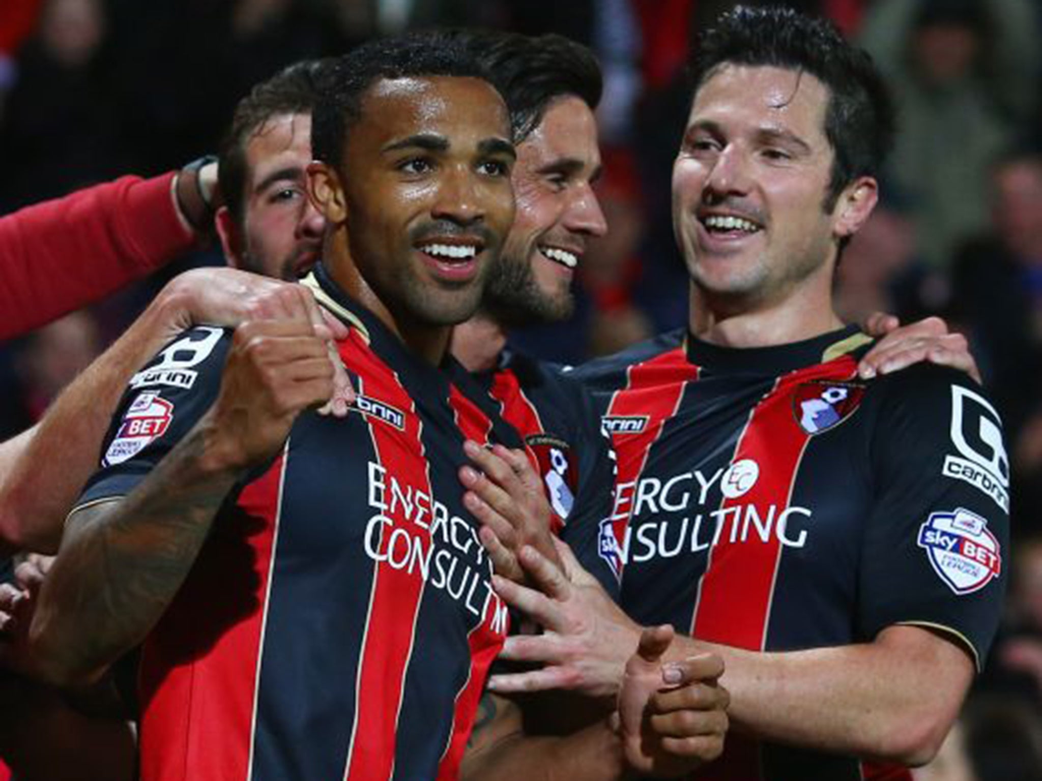 Callum Wilson, left, celebrates scoring Bournemouth’s third in a 3-0 win over Bolton that effectively clinches promotion