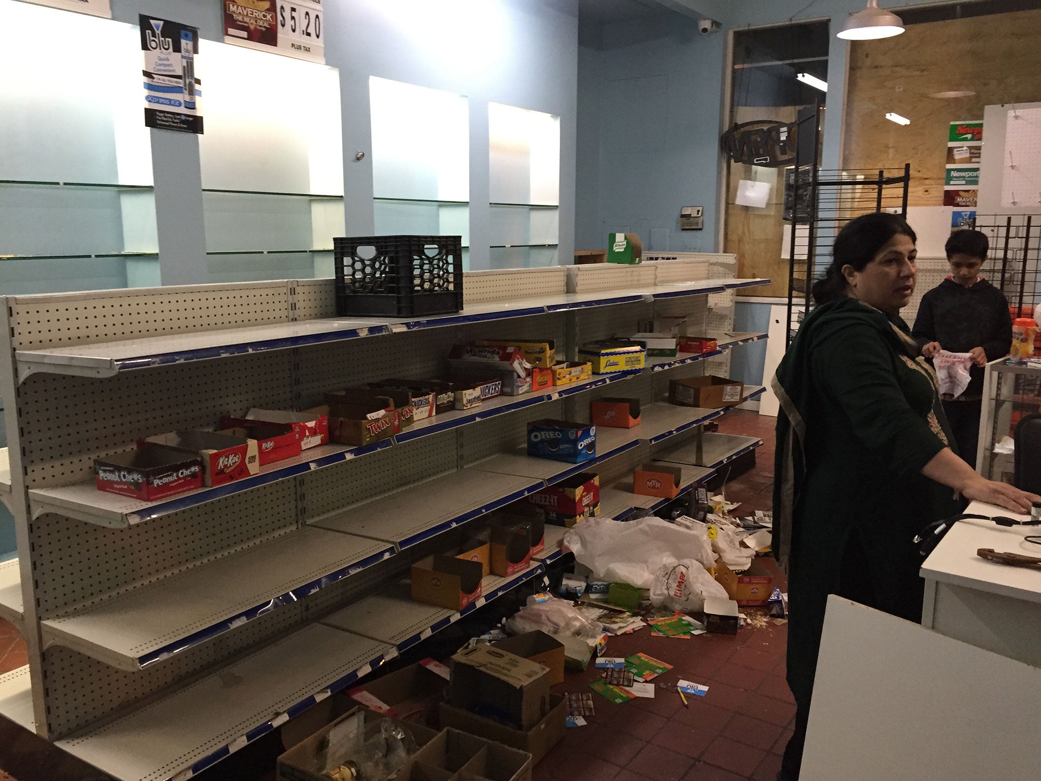 The Shaheed family assess the damage to their store in downtown Baltimore