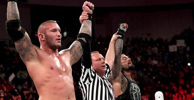 Randy Orton and Roman Reigns celebrate defeating Seth Rollins and Kane