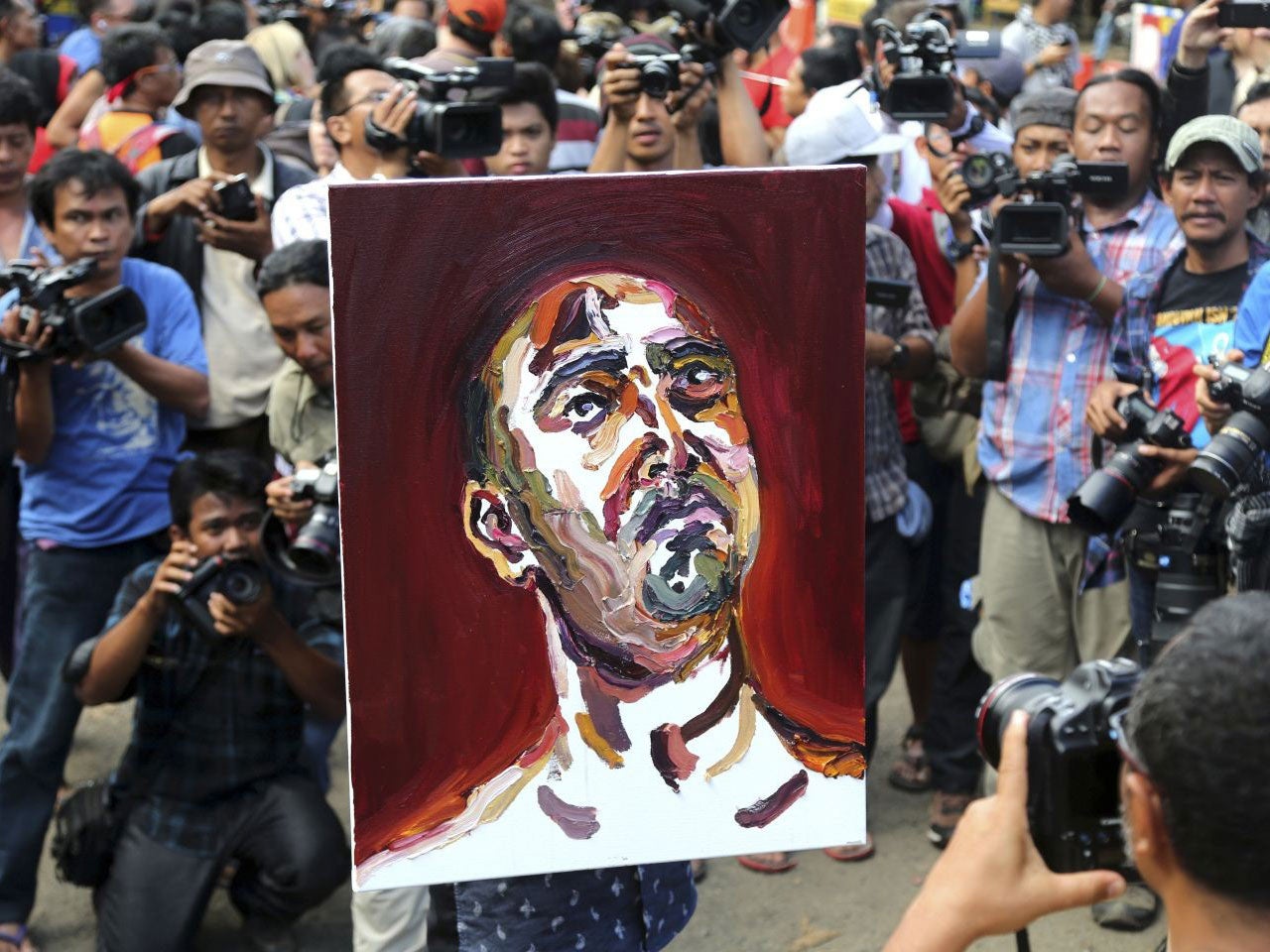 A lawyer carries a self-portrait drawn by Myuran Sukumaran after visiting the prison island of Nusakambangan on 27 April