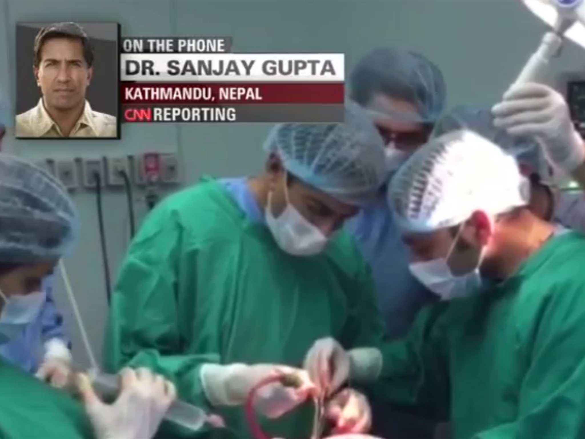 Dr Sanjay Gupta in the operating theatre (centre)