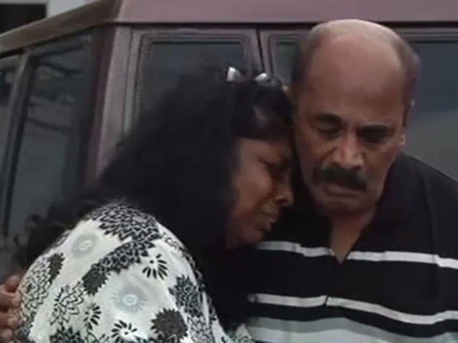 The parents of Myuran Sukumaran console each other after seeing their son for what could be the last time