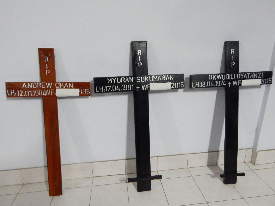 Crosses for condemned drug convicts (from L-R) Australians Andrew Chan (L) and Myuran Sukumaran (C), and Nigerian Okwudili Oyatanze