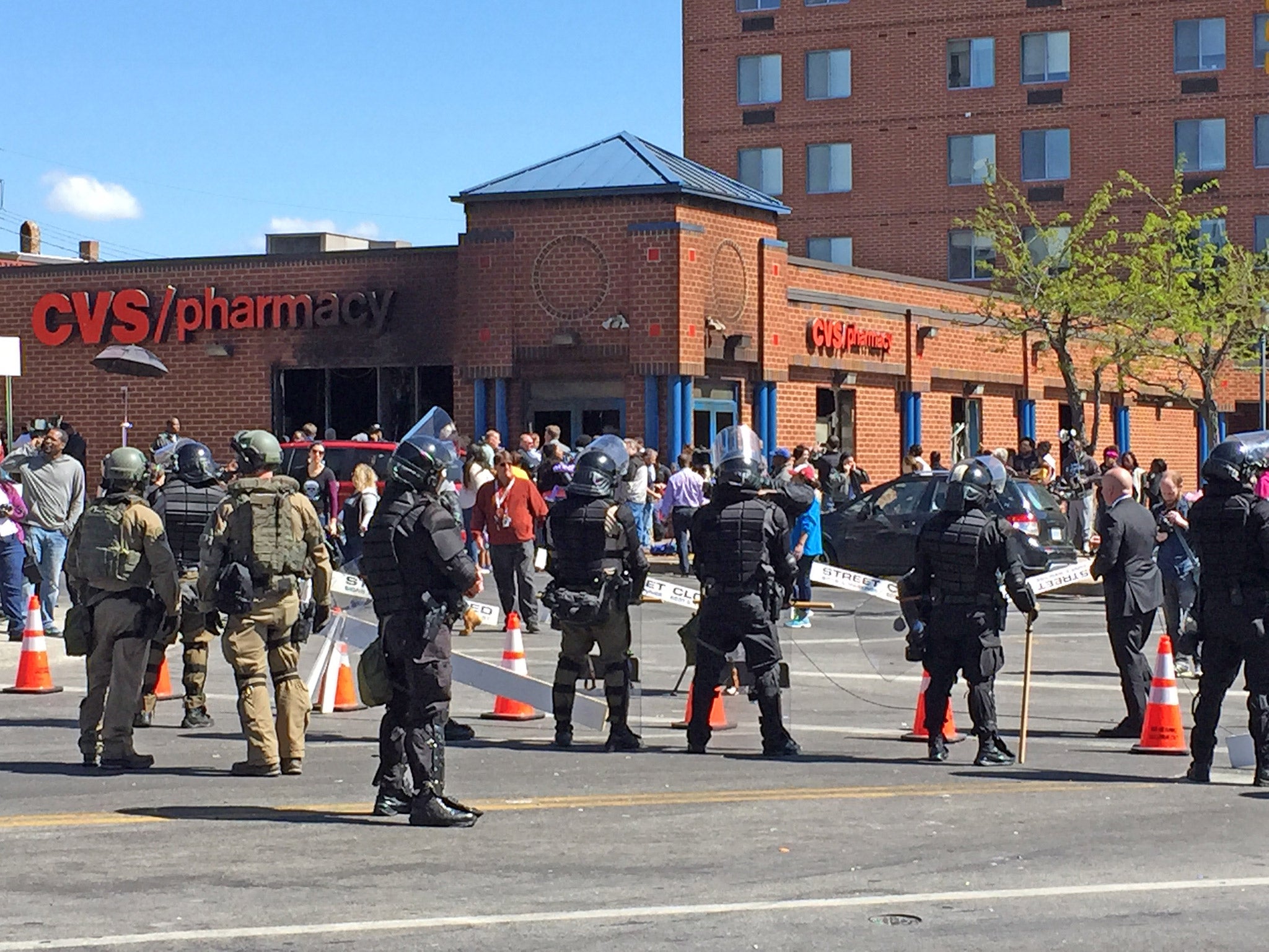 Police and National Guard keep the peace outside the fire-damaged CVS pharmacy store