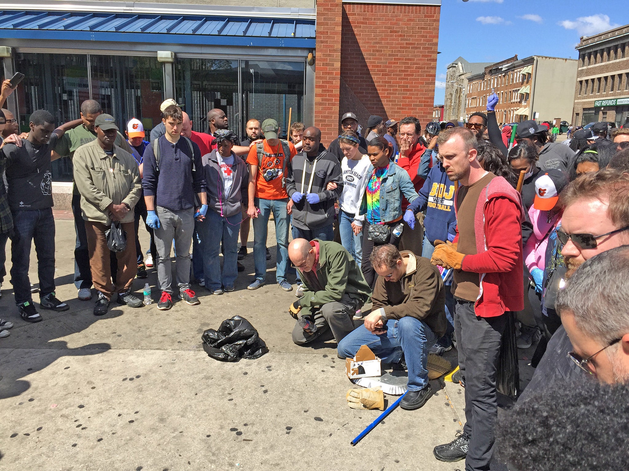 Volunteers say a prayer before Tuesday's clean-up