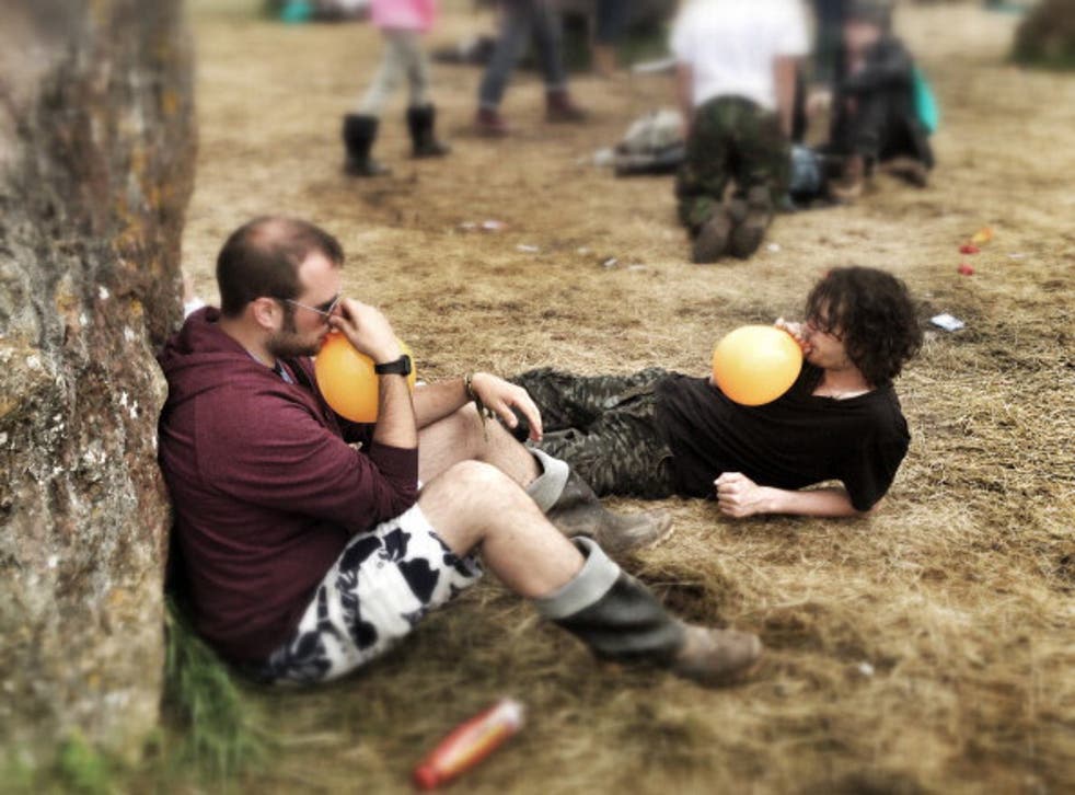 Glastonbury festival-goers inhale nitrous oxide out of balloons