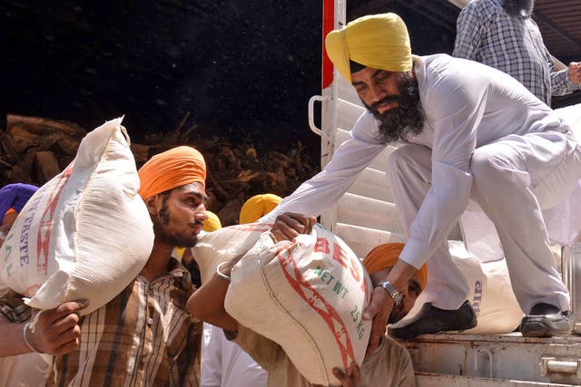 Volunteers load relief material for Nepal in Amritsar, India