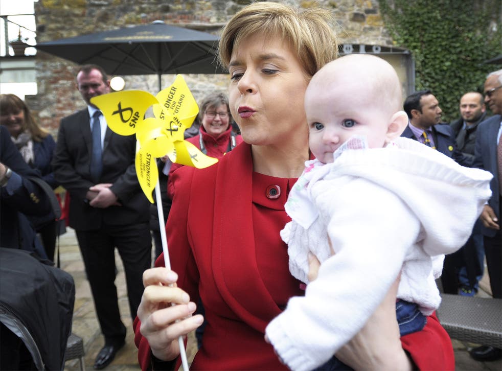 SNP leader Nicola Sturgeon holds a baby while campaigning in South Queensferry, Edinburgh