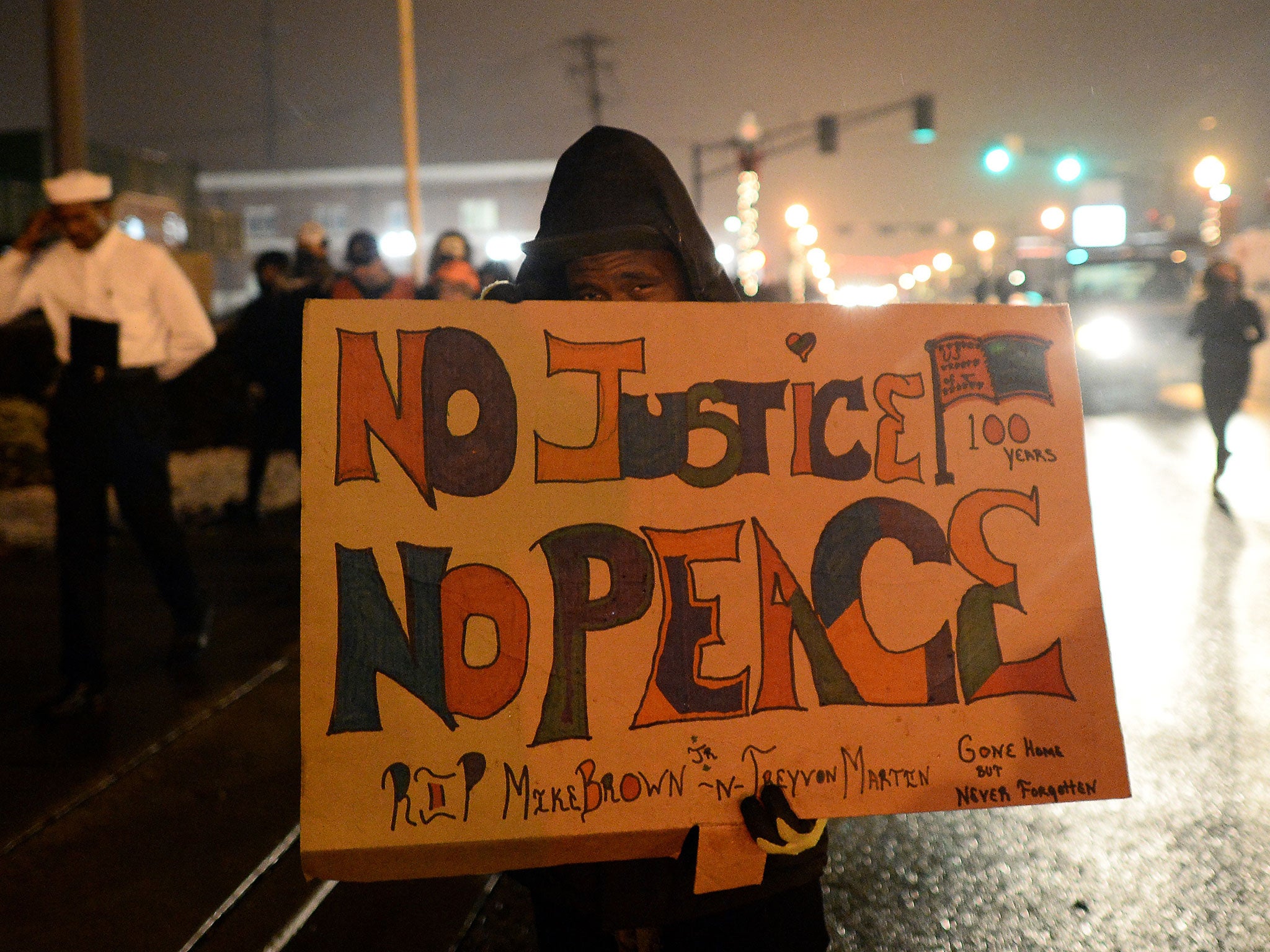 A demonstrator marching last year in protest against the shooting of Michael Brown