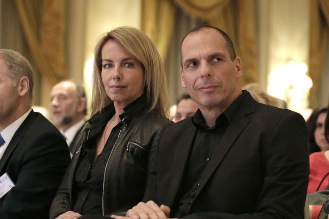 Greek Finance Minister Yanis Varoufakis, right, attends a banking conference in Athens with his wife Danae Stratou on 21 April