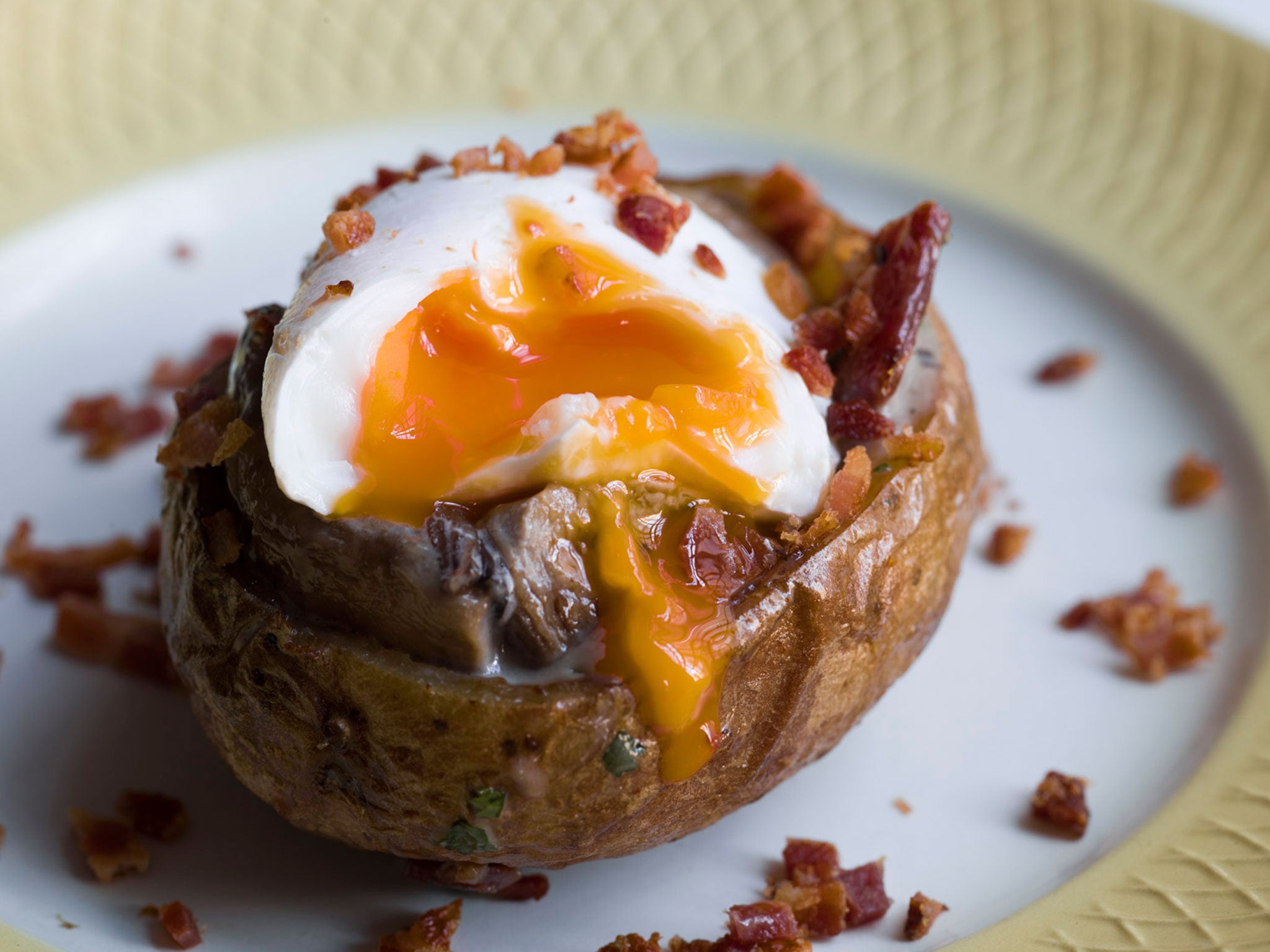 Mark has added bacon, sausages, mushrooms, and egg to his breakfast potatoes