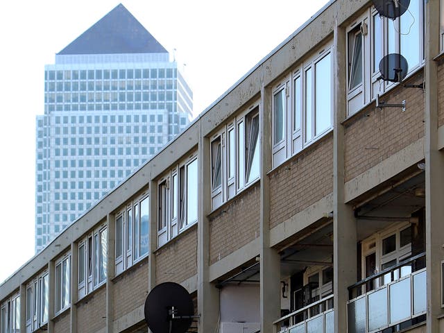 Canary Wharf rises above an area of council housing in Tower Hamlets