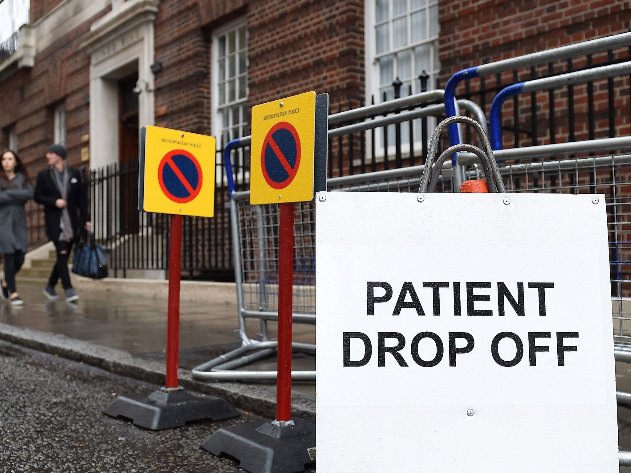 A couple walk past the Lindo Wing at St.Mary's Hospital in north London, Britain, 29 April 2015