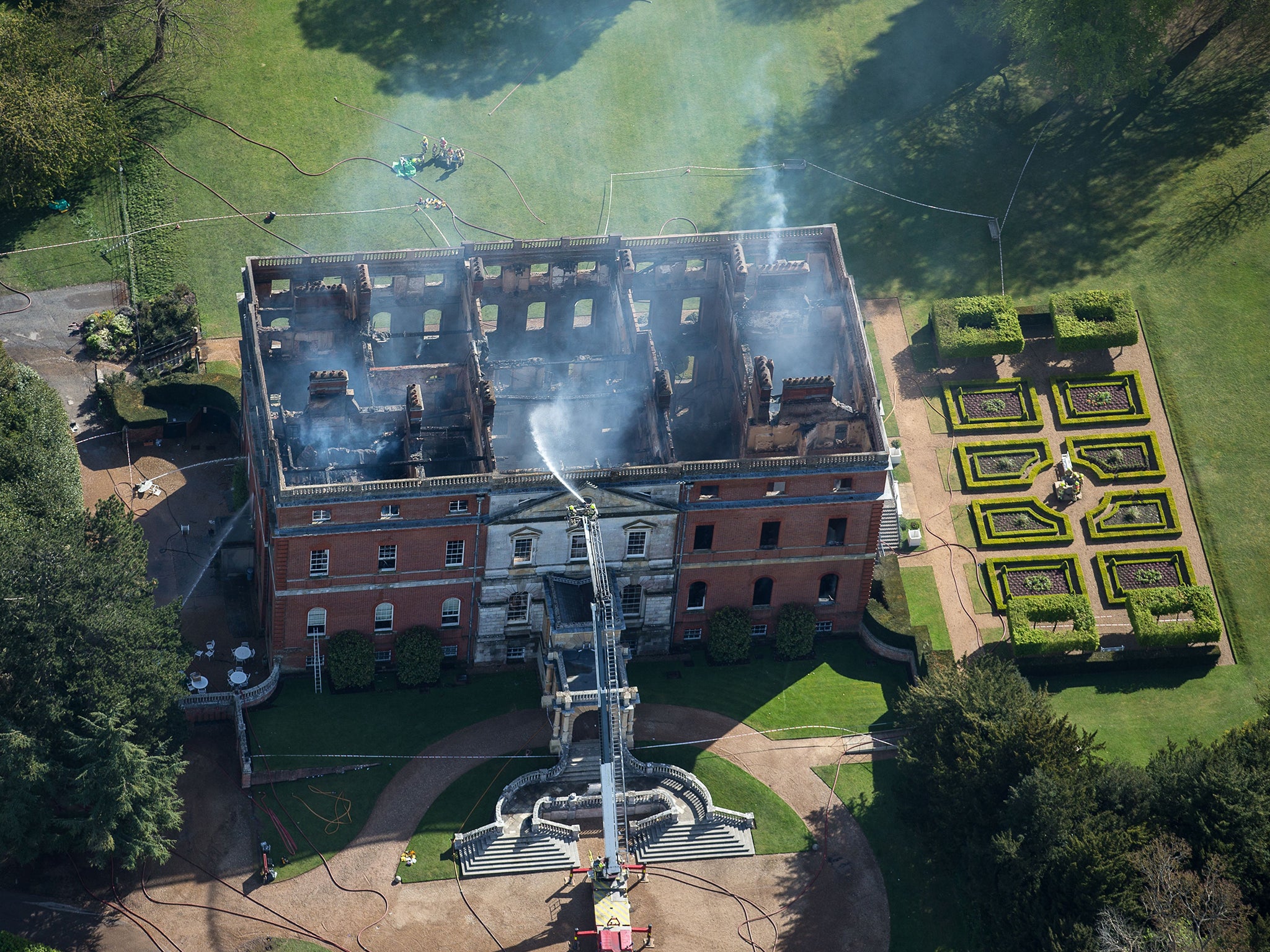 The burnt-out Grade I-listed Clandon Park in Surrey yesterday