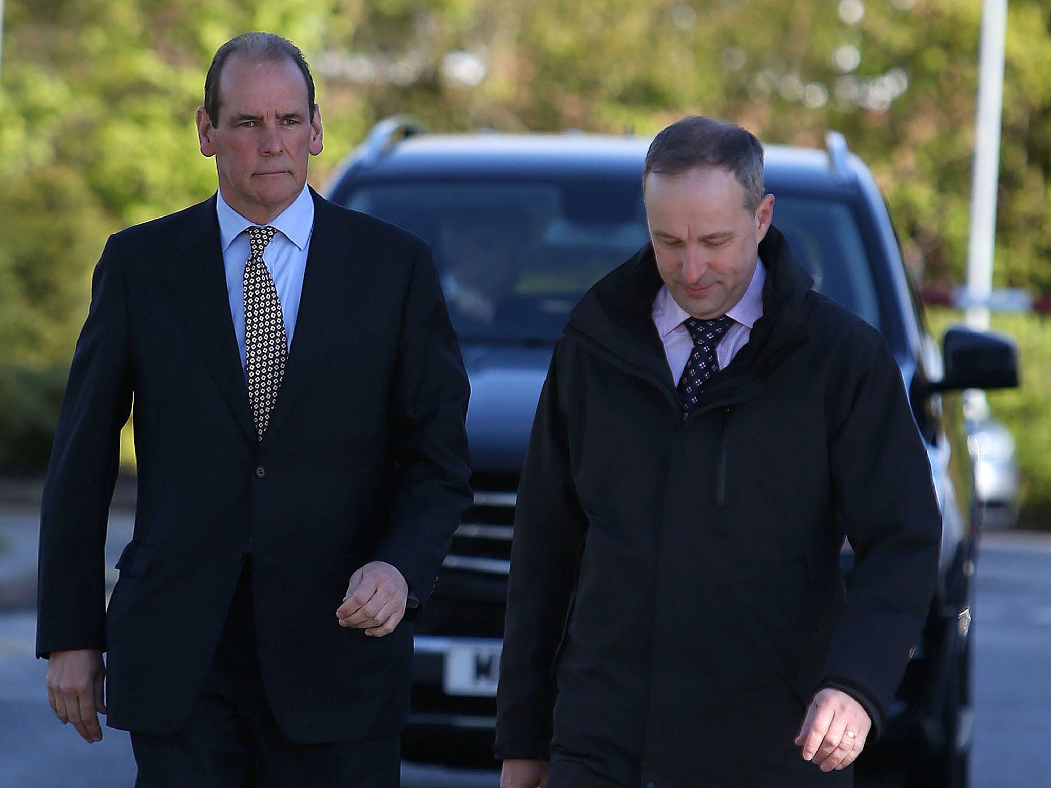 Sir Norman Bettison (left) arrives to give evidence at the inquests in Warrington
yesterday