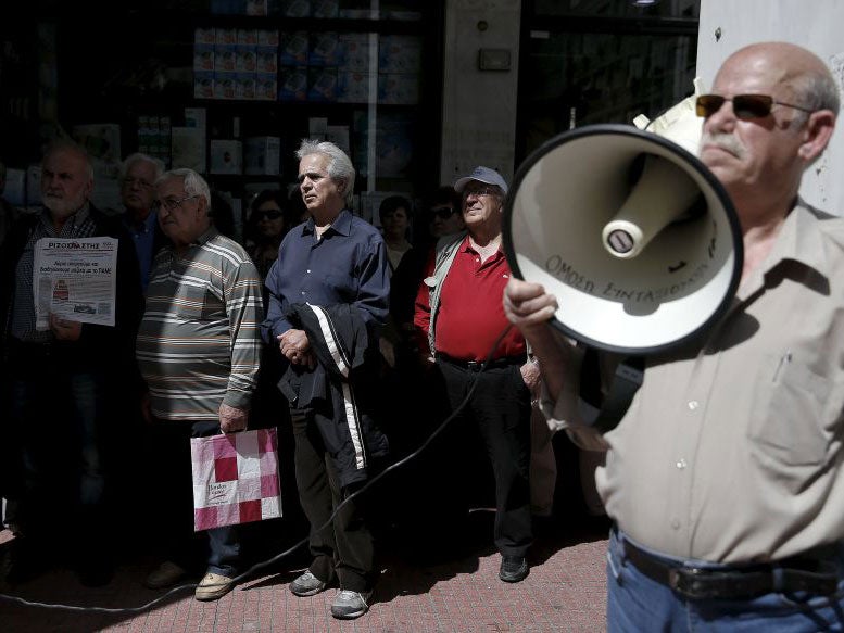 Greek pensioners stage a protest outside the Social Insurance Foundation headquarters against a government's decision to order state entities to park idle cash at the central bank