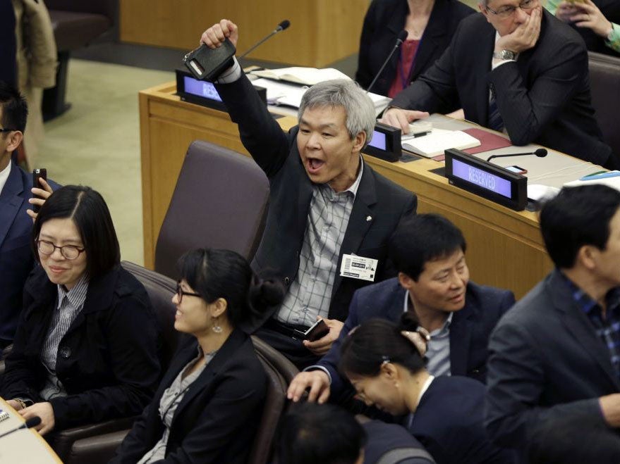 A North Korean defector shouts over a statement being read by North Korean diplomats during a panel on North Korean human rights abuses