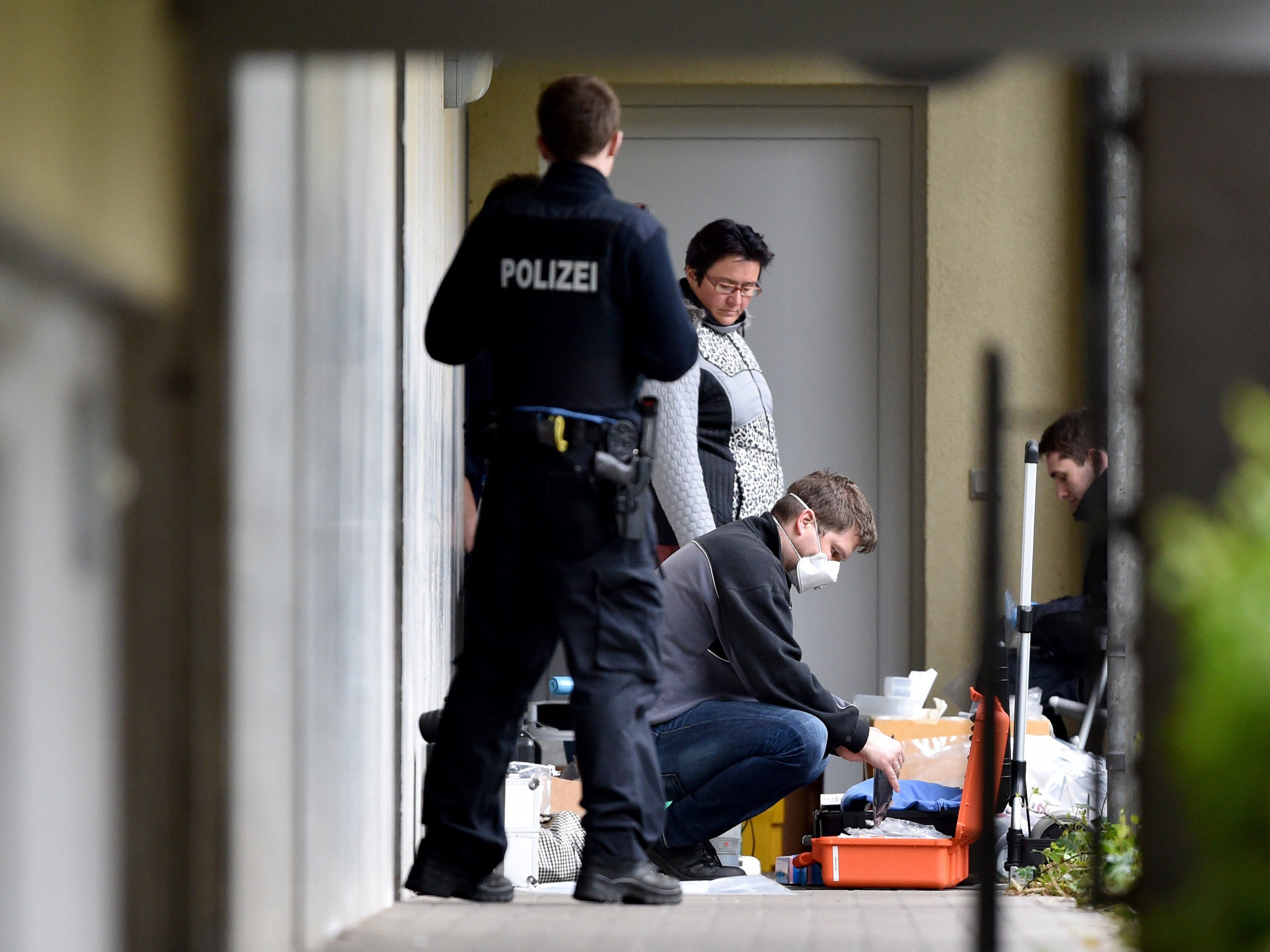 Experts from the police secure evidence at the couple's apartment complex in Oberursel