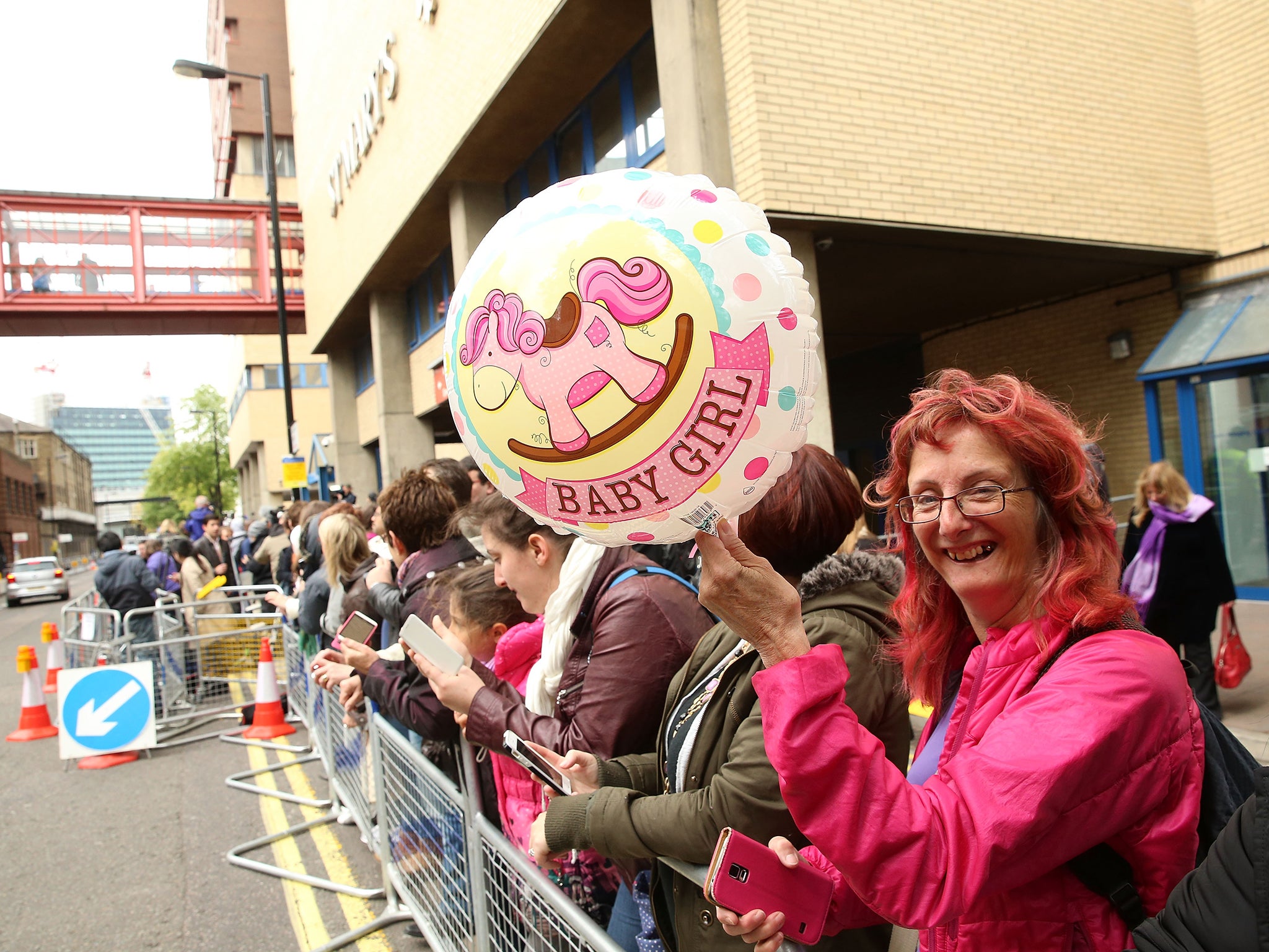 Well-wishers and media gather outside the hospital