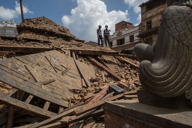 Rescuers look down on debris at Basantapur Durbar Square in Kathmandu last week